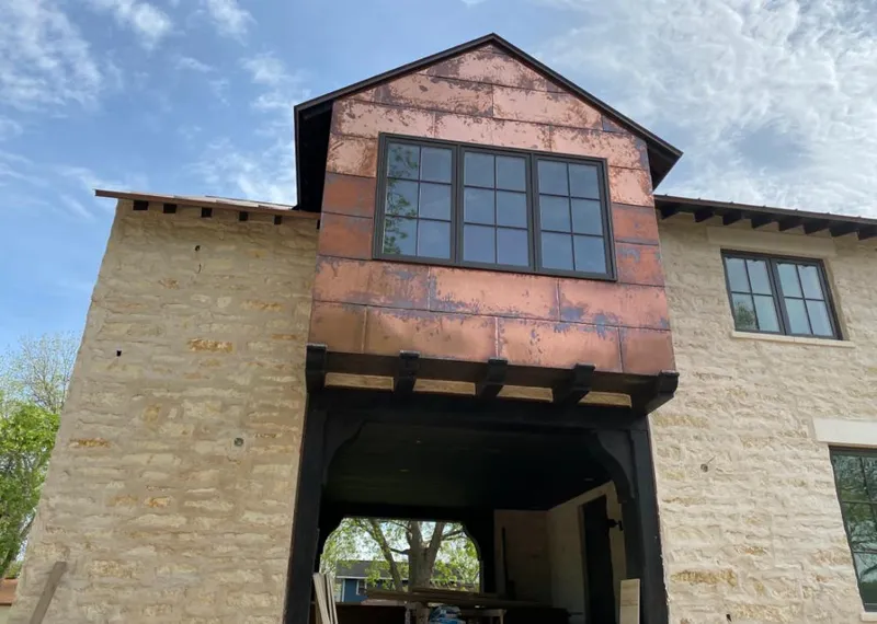 Copper metal panel facade on a stone building for Roof Repair in Pike Creek
